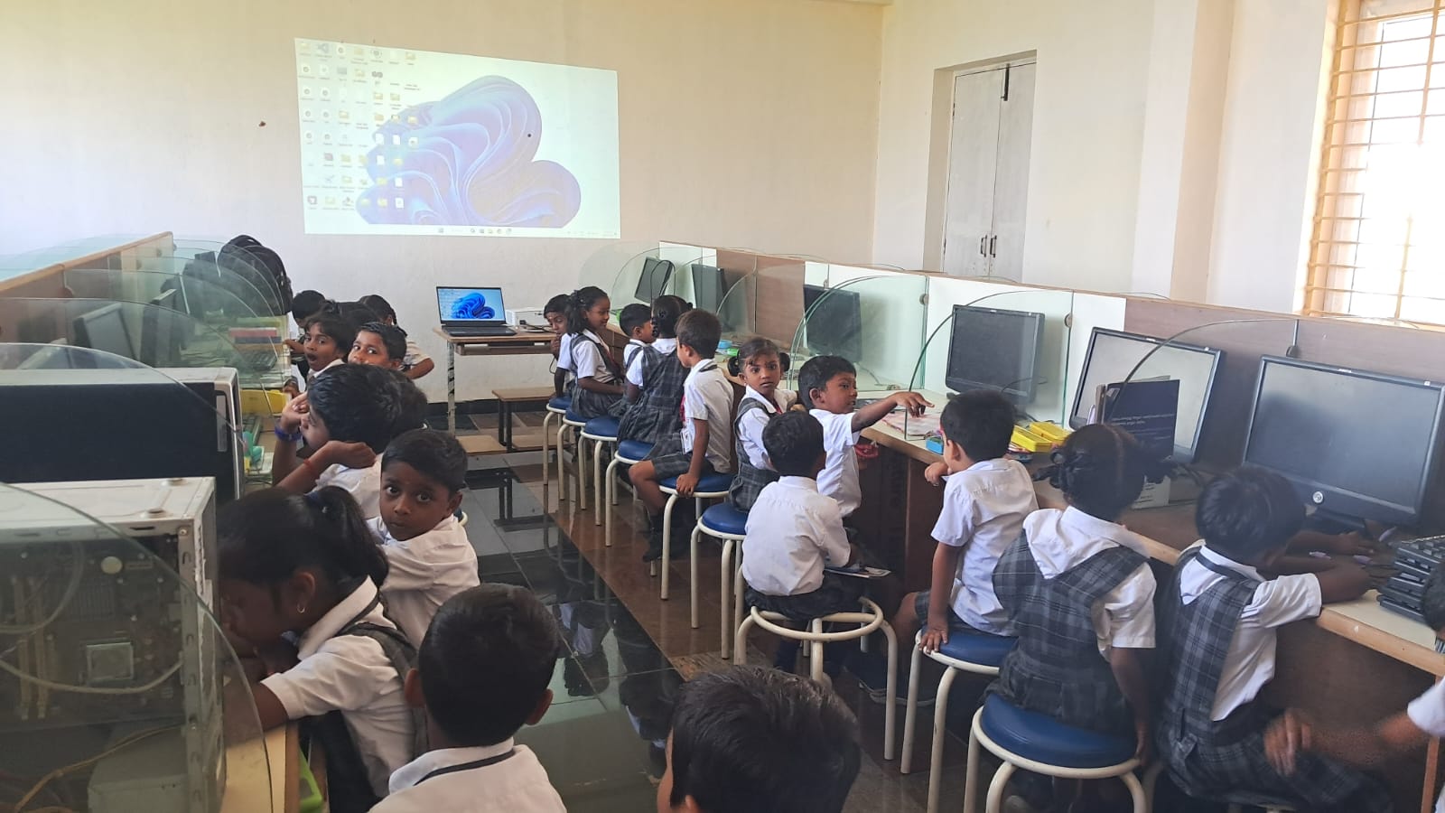 A modern computer lab with rows of computers.
