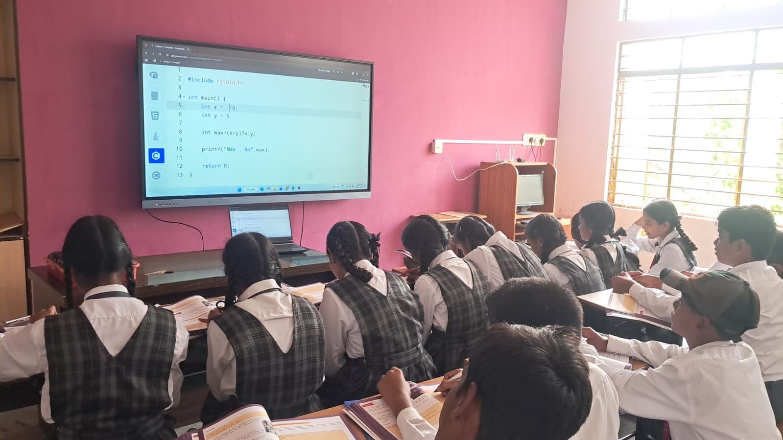 A classroom with a large smart screen display.